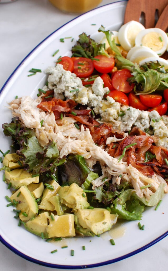 Cobb Salad Recipe with wooden tongs