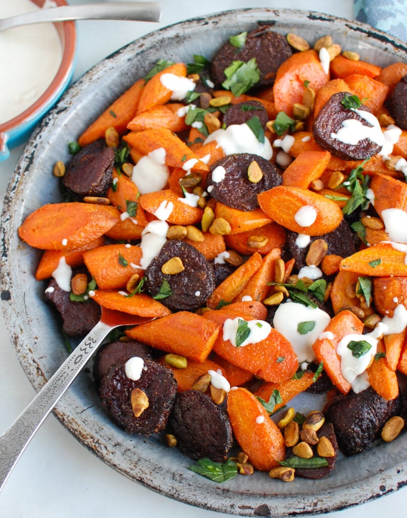 Roasted Carrots and Beets with Tahini with serving spoon 