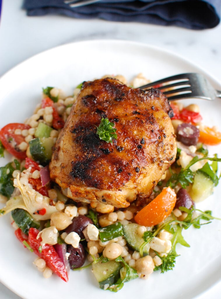 Grilled Chicken Thighs with Greek Marinade on white plate 