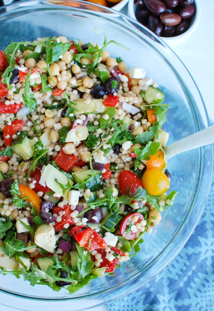 Mediterranean Couscous Salad in clear bowl 