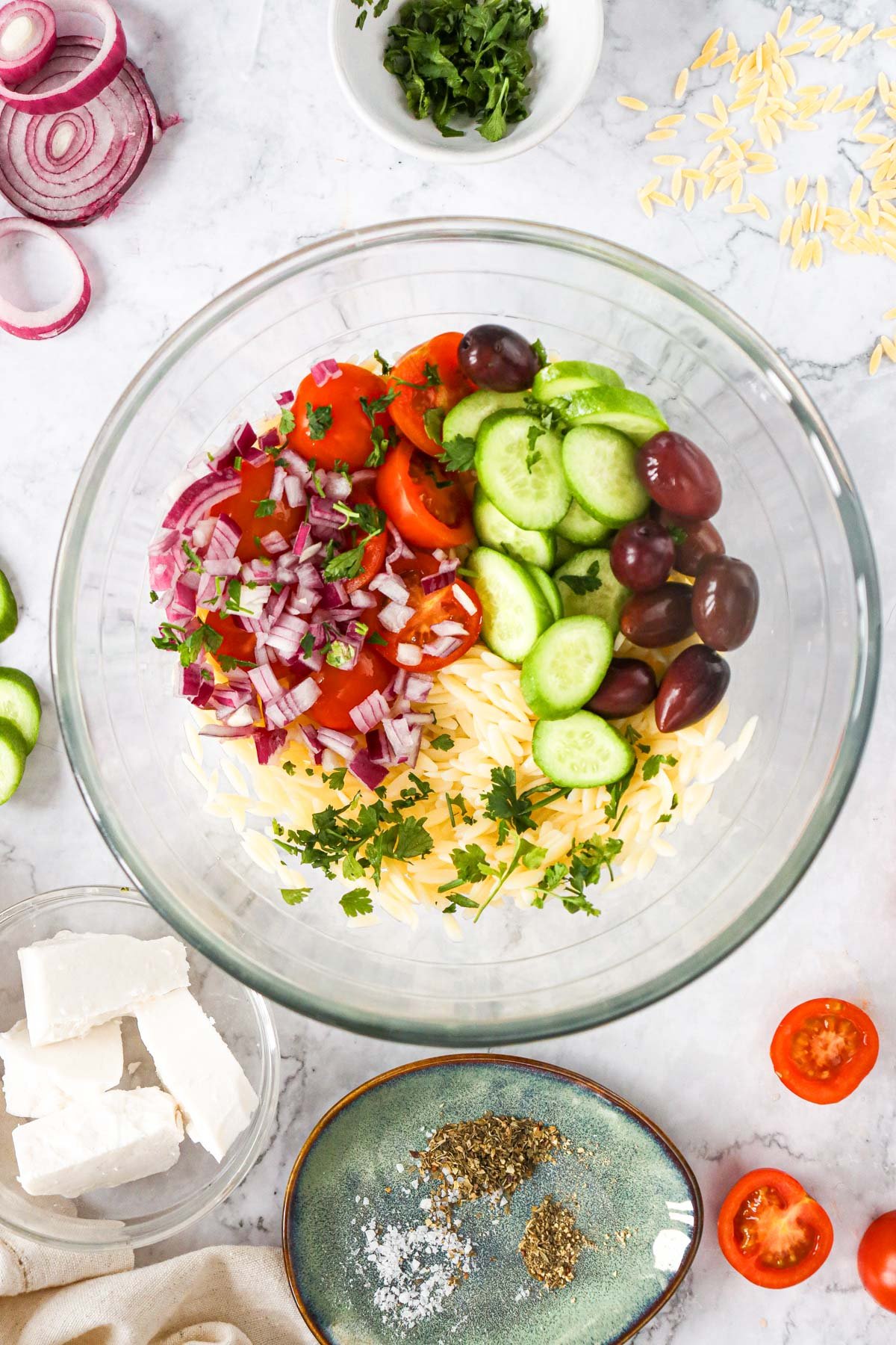 Greek Orzo Pasta Salad ingredients in a bowl 