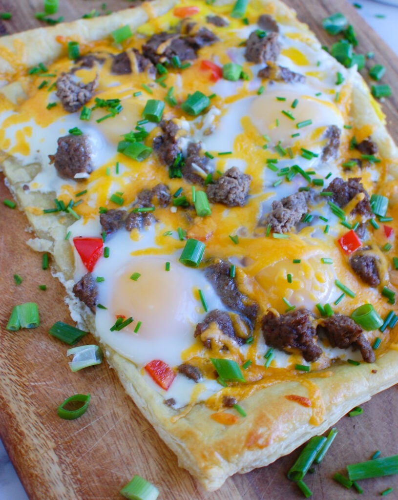 Turkey Sausage and Egg Puff Pastry Pizza on cutting board 