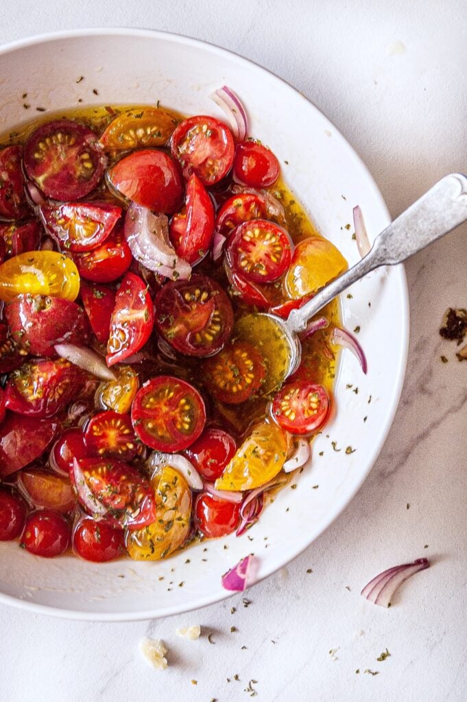 Simple Marinated Tomatoes with spoon 