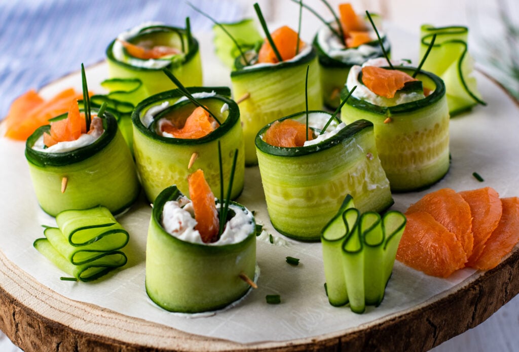 Smoked Salmon Cucumber Appetizer Bites on a wood platter 
