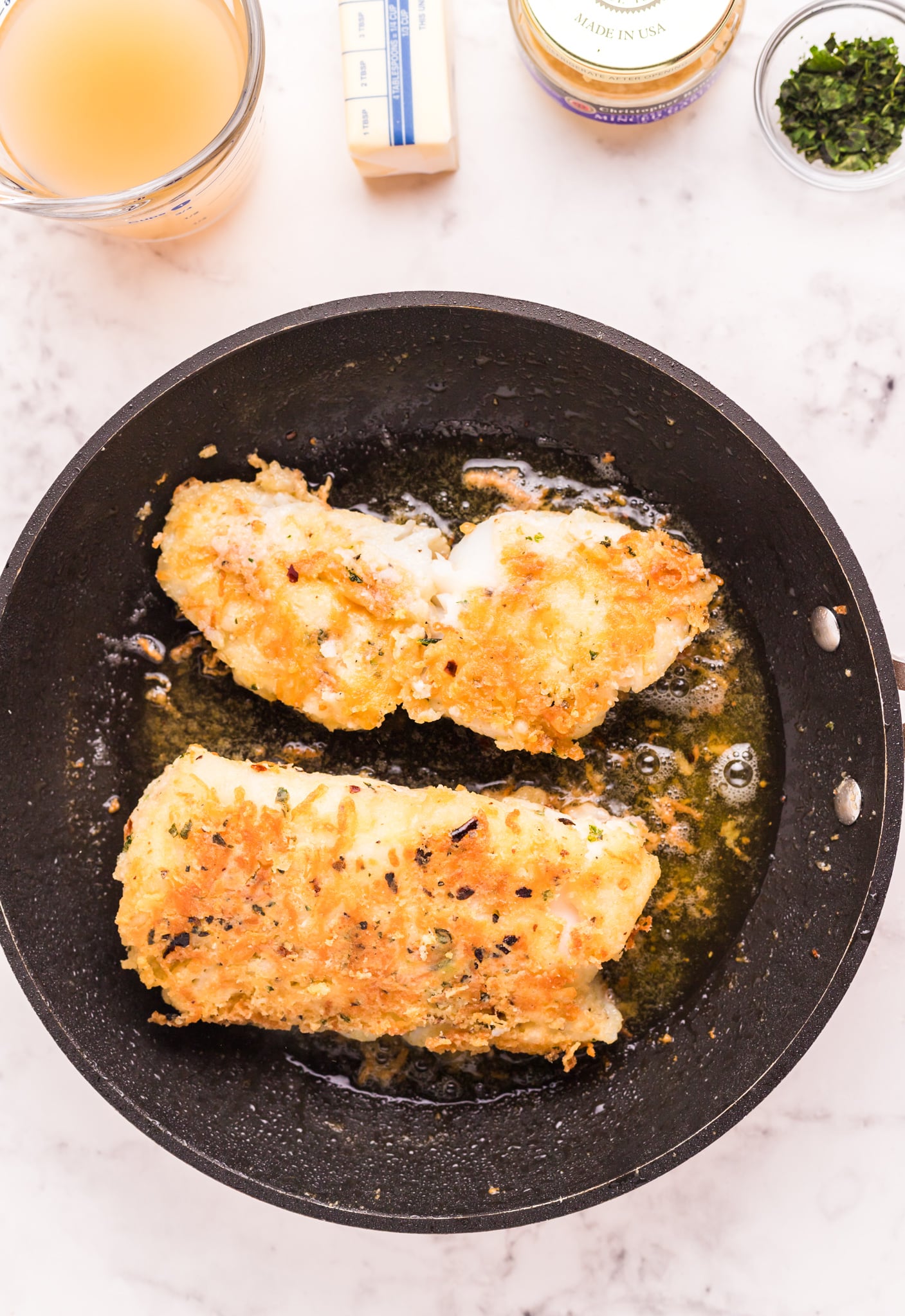 Pan Fried Garlic Butter Cod browned in skillet