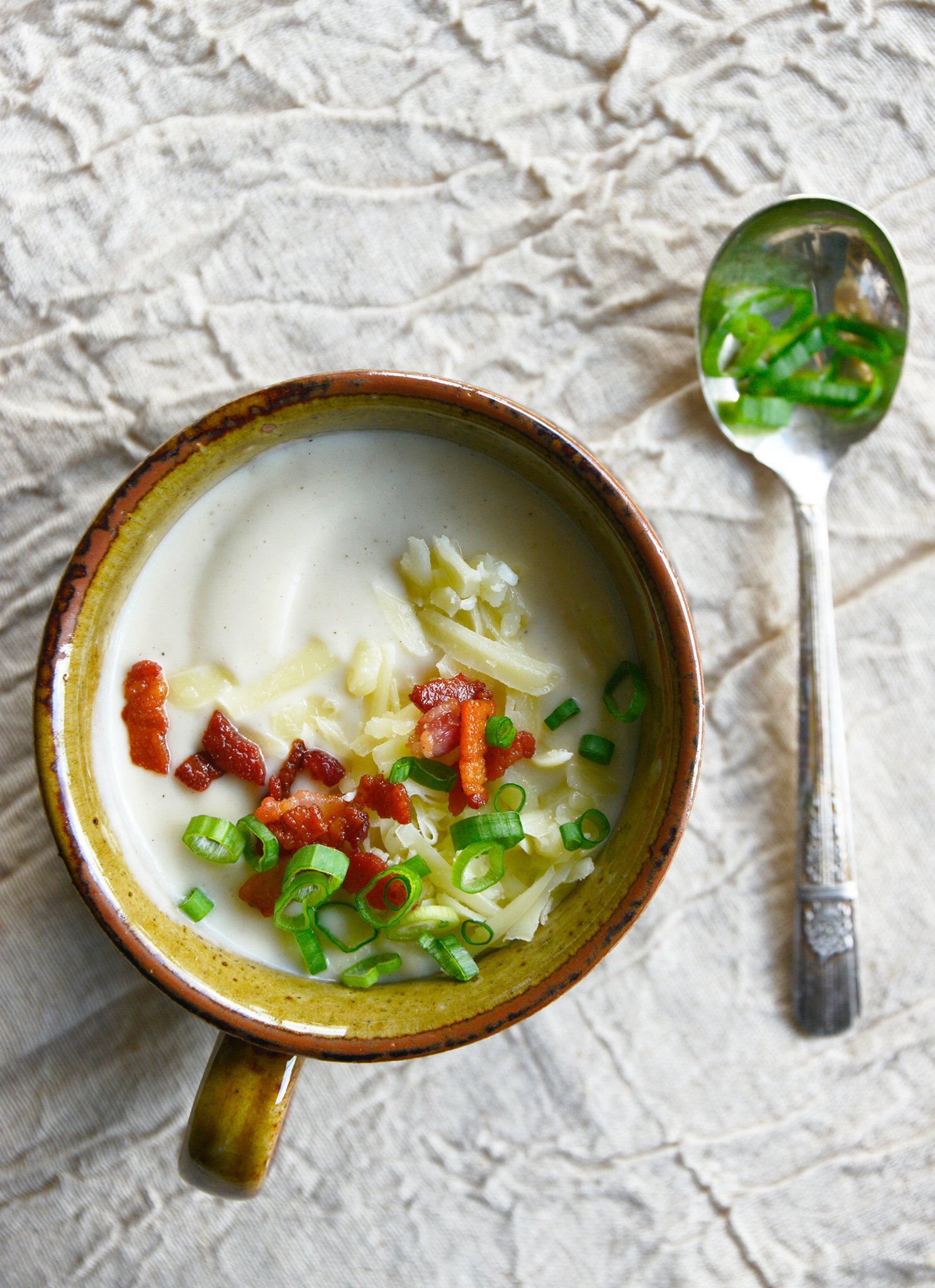Instant Pot Cauliflower Soup with green onions on the soup.