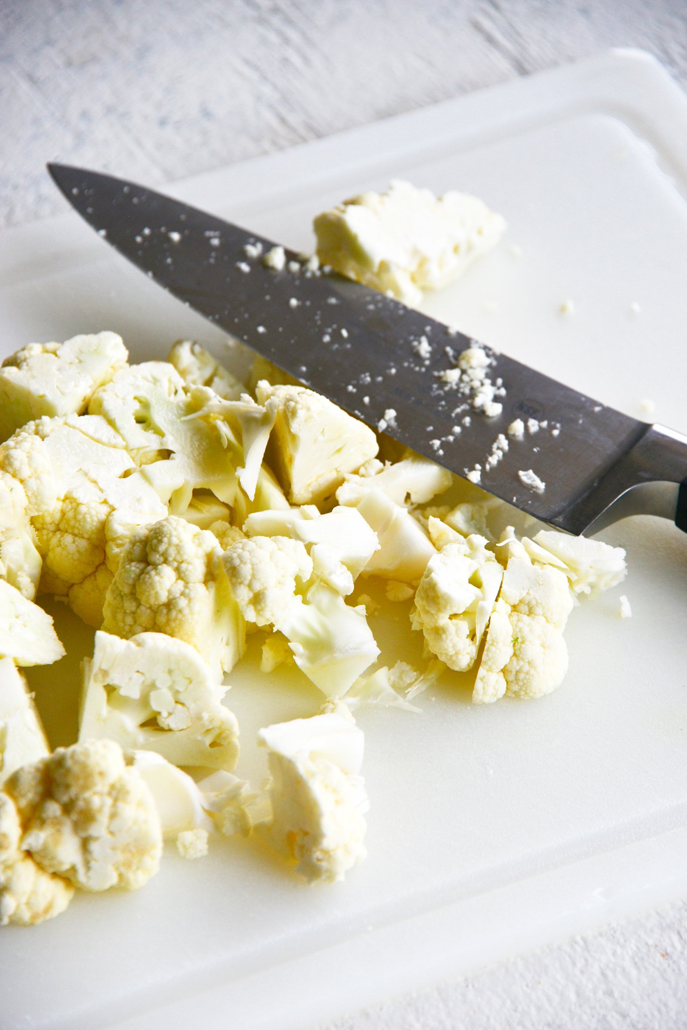 Instant Pot Cauliflower Soup cauliflower with a knife.