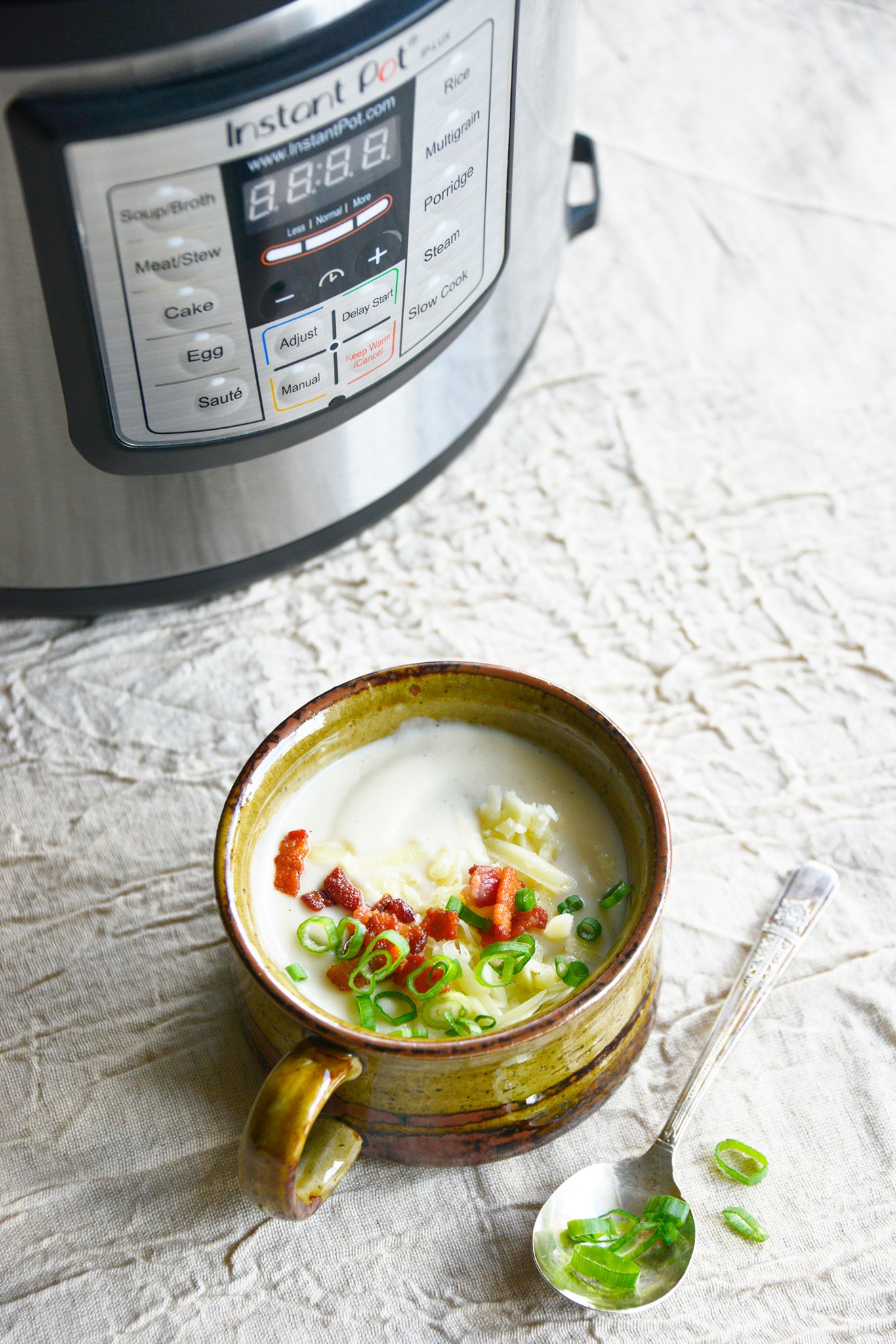 Instant Pot Cauliflower Soup with Instant Pot in background. 