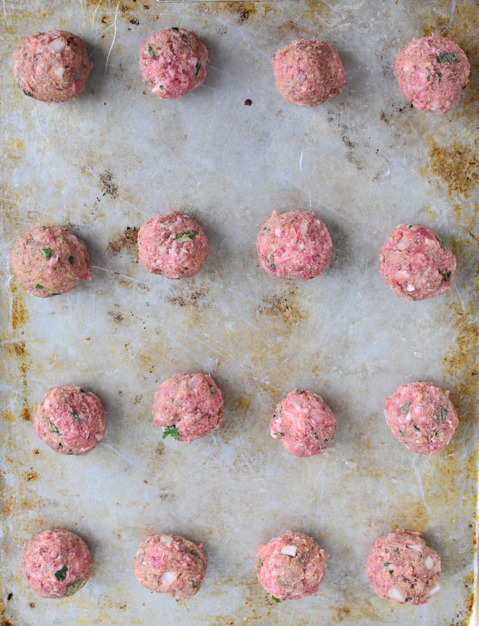 Lamb Kofta raw meatballs on a baking sheet. 