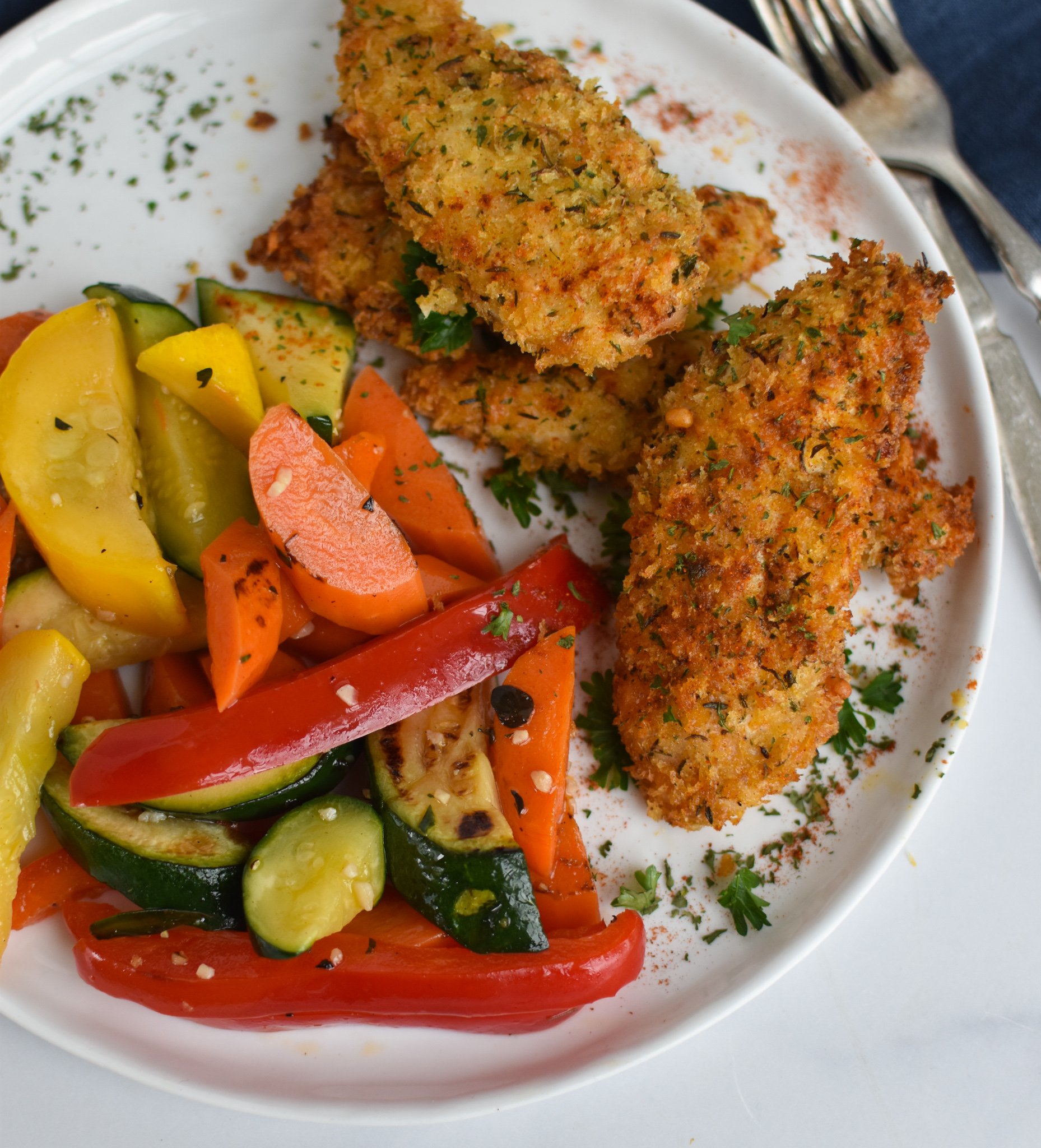 Air Fryer Chicken Tenders with parsley as a garnish.