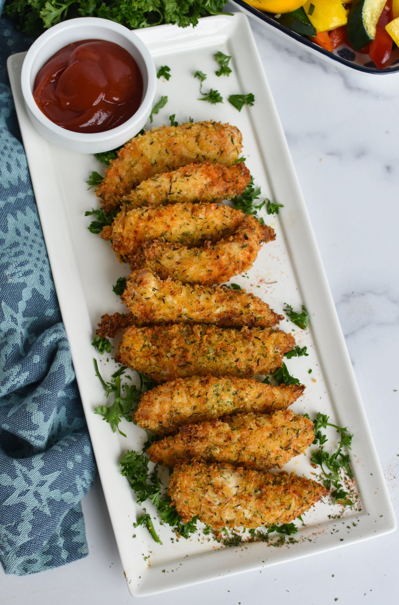 Air Fryer Chicken Tenders on a white long platter.