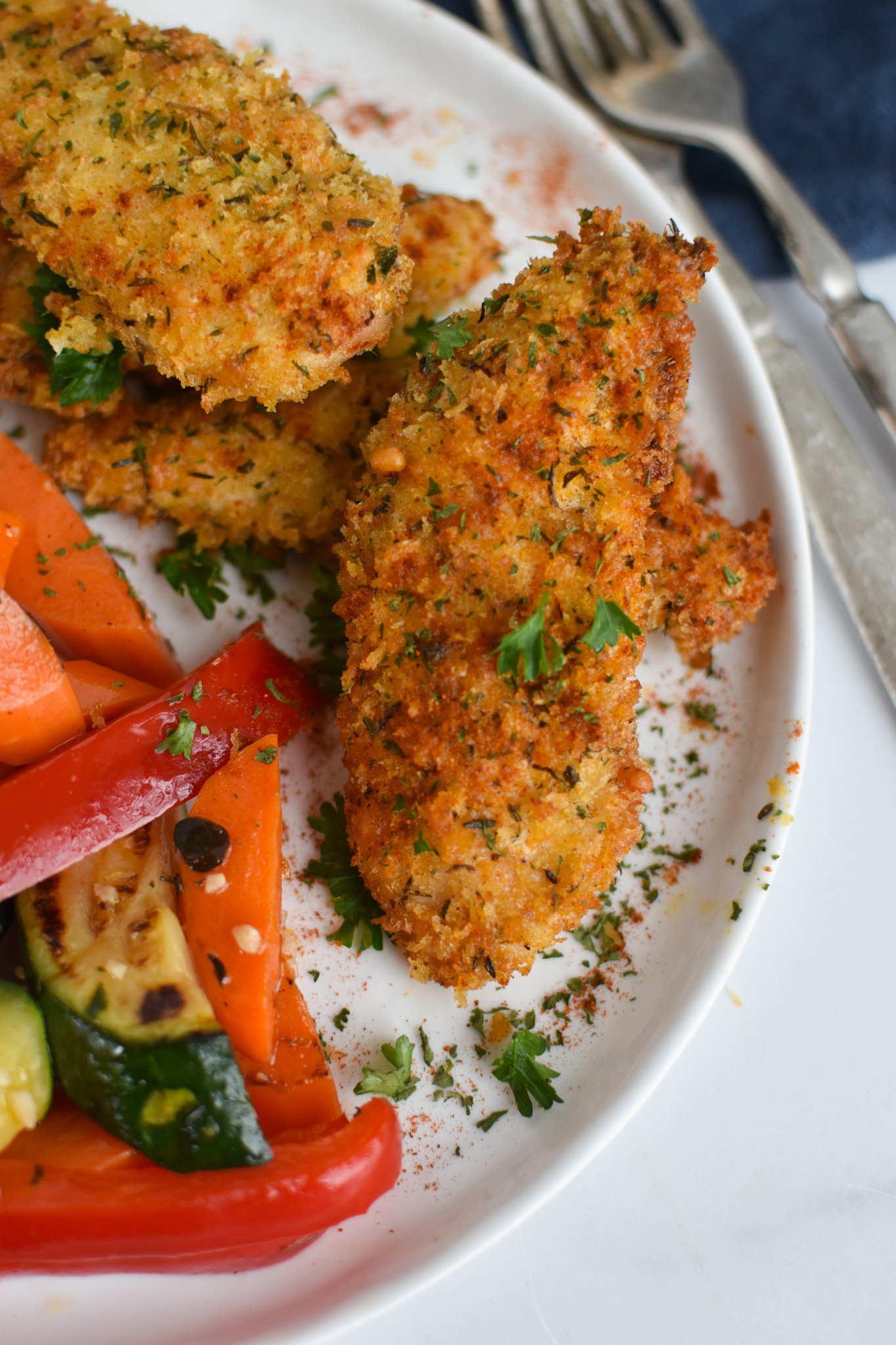 Air Fryer Chicken Tenders with vegetables on a plate.