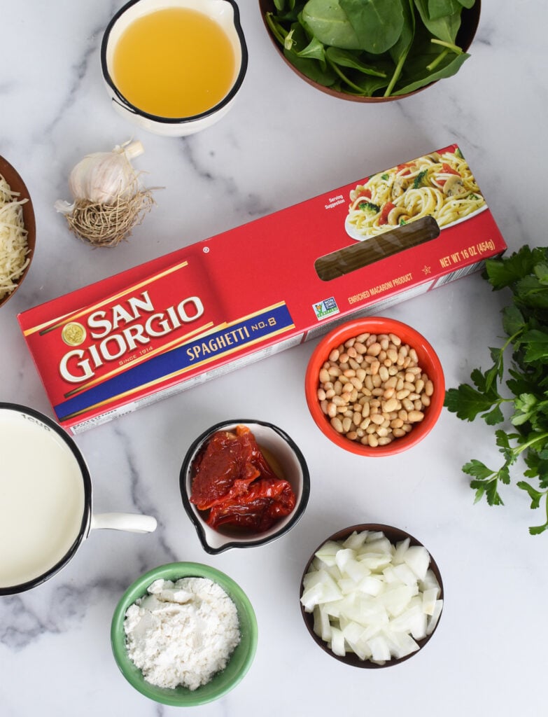 Creamy Sun Dried Tomato Pasta Recipe ingredients on a white board.