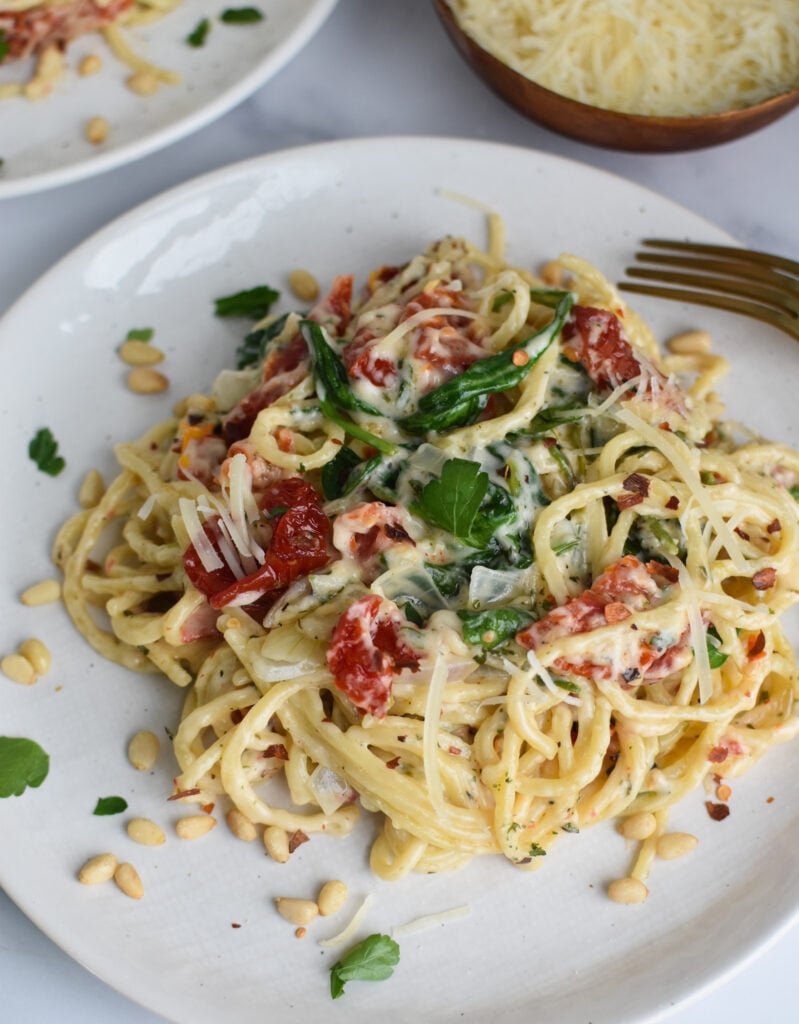 Creamy Sun Dried Tomato Pasta Recipe on a white plate.