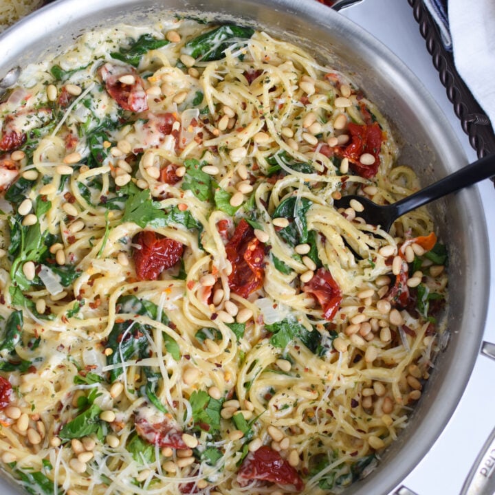 Creamy Sun Dried Tomato Pasta Recipe with a spoon in the pan.