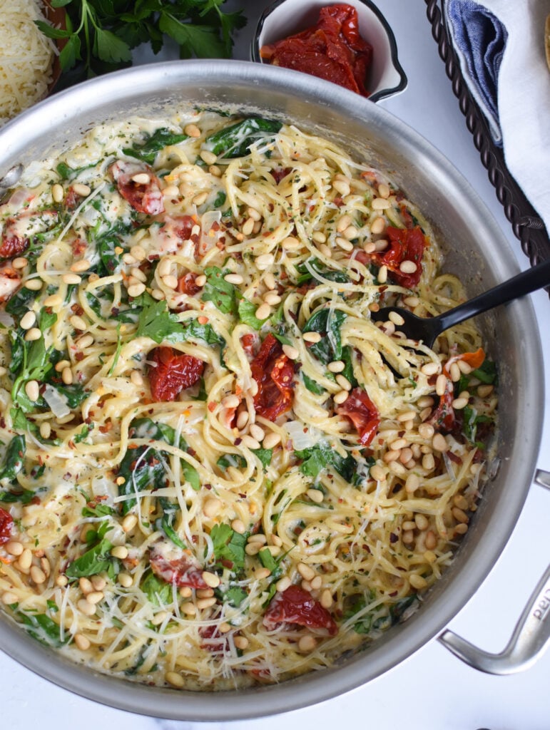 Creamy Sun Dried Tomato Pasta Recipe with a spoon in the pan.