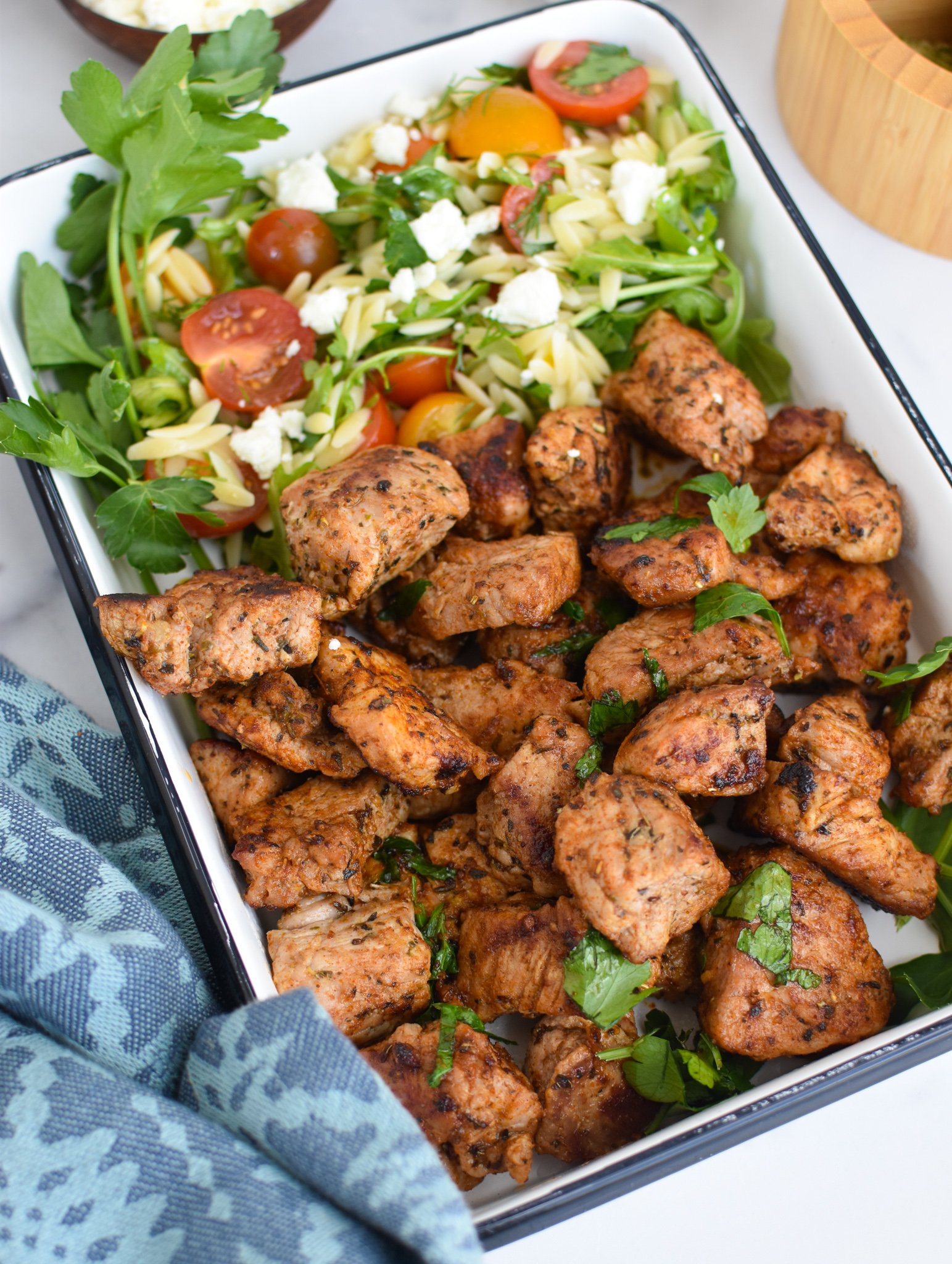 Cast Iron Pork Tenderloin in a white square dish.