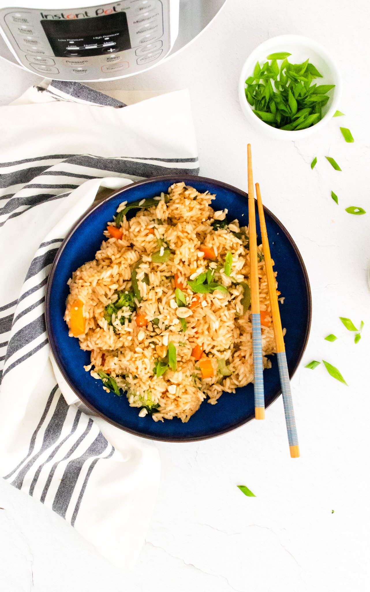Instant Pot Fried Rice with chopsticks in a blue bowl. 