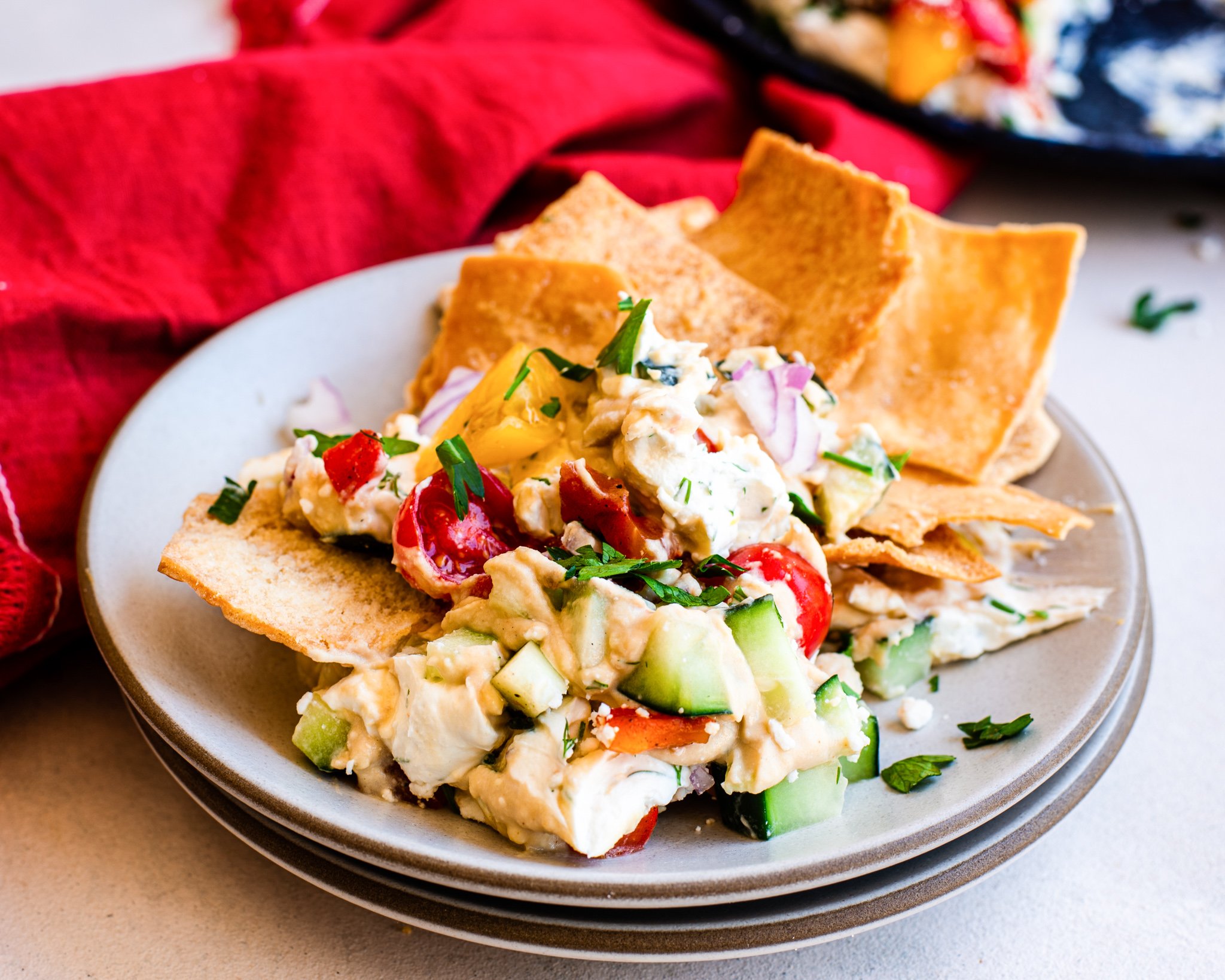 Layered Greek Dip with pita chip. 