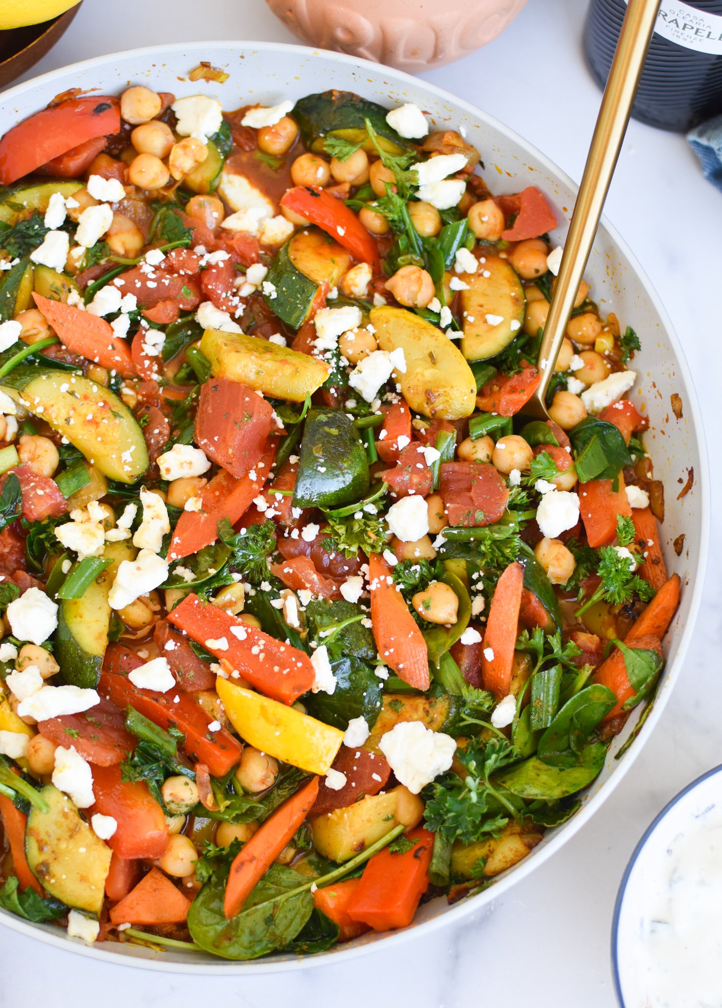 Mediterranean Chickpea Skillet with gold spoon. 