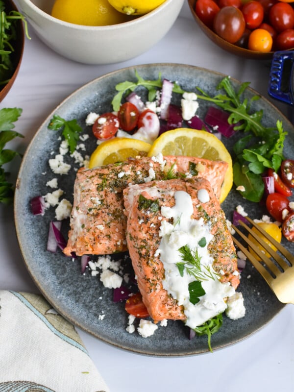 Pan Seared Greek Salmon on a blue plate.