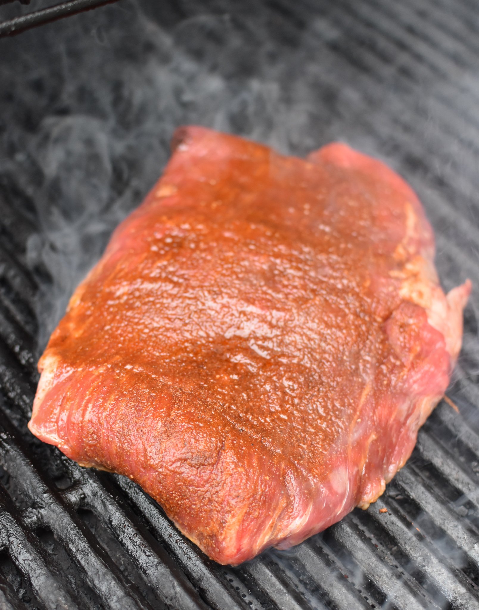 Grilled Flank Steak with Dry Rub on grill. 