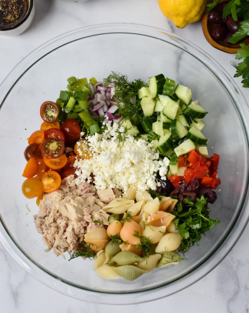Mediterranean Tuna Pasta Salad ingredients in a bowl 