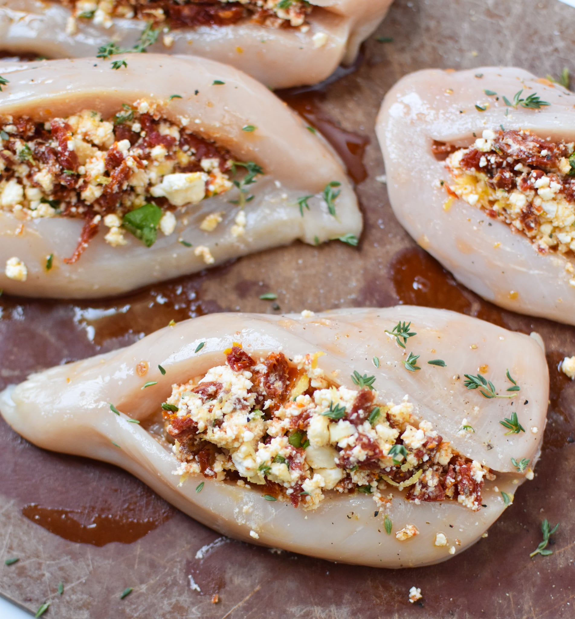 Sun-dried Tomato Goat Cheese Stuffed Chicken Breasts on cutting board.