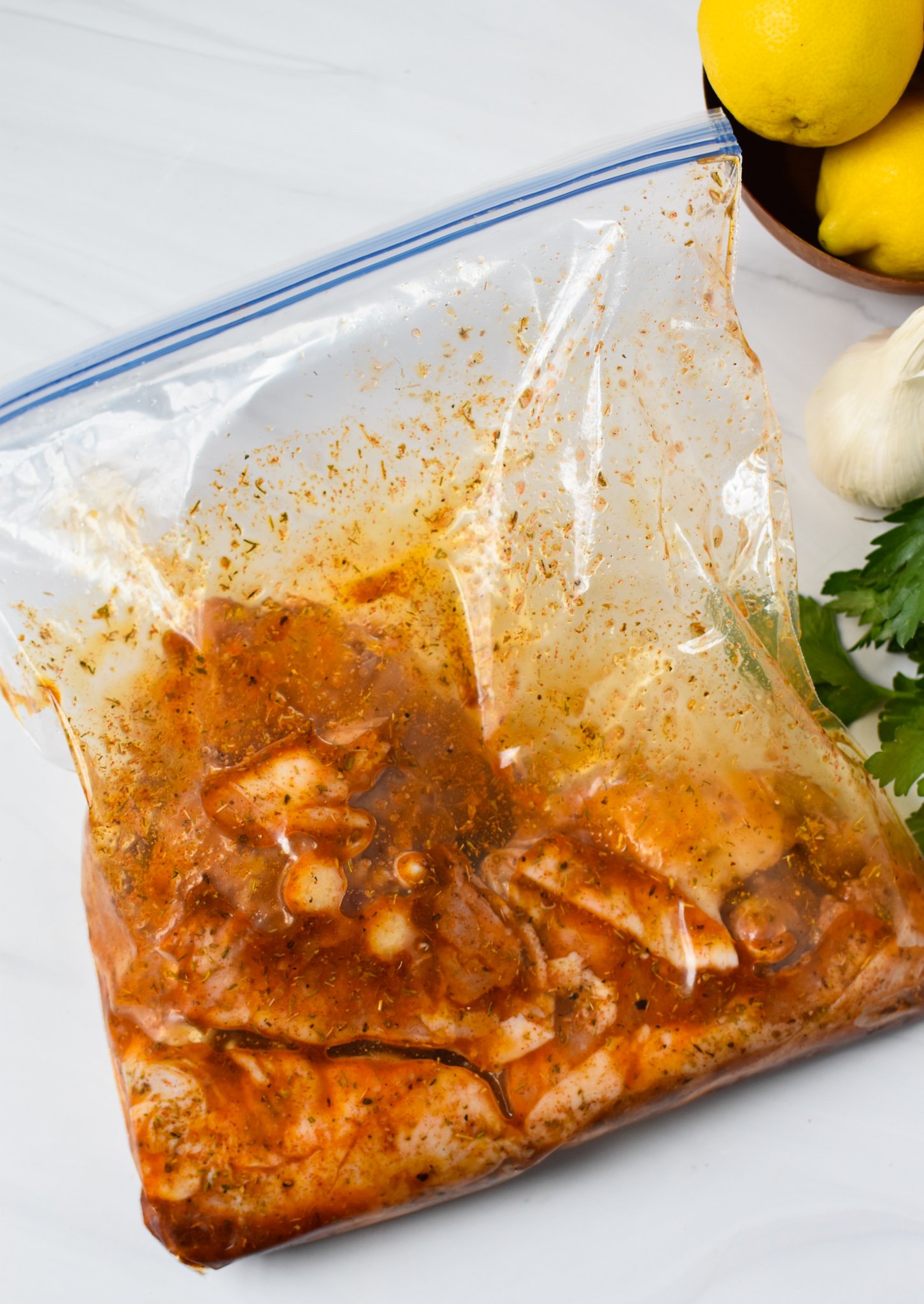 Air Fryer Mediterranean Chicken Thighs in a ziplock bag.