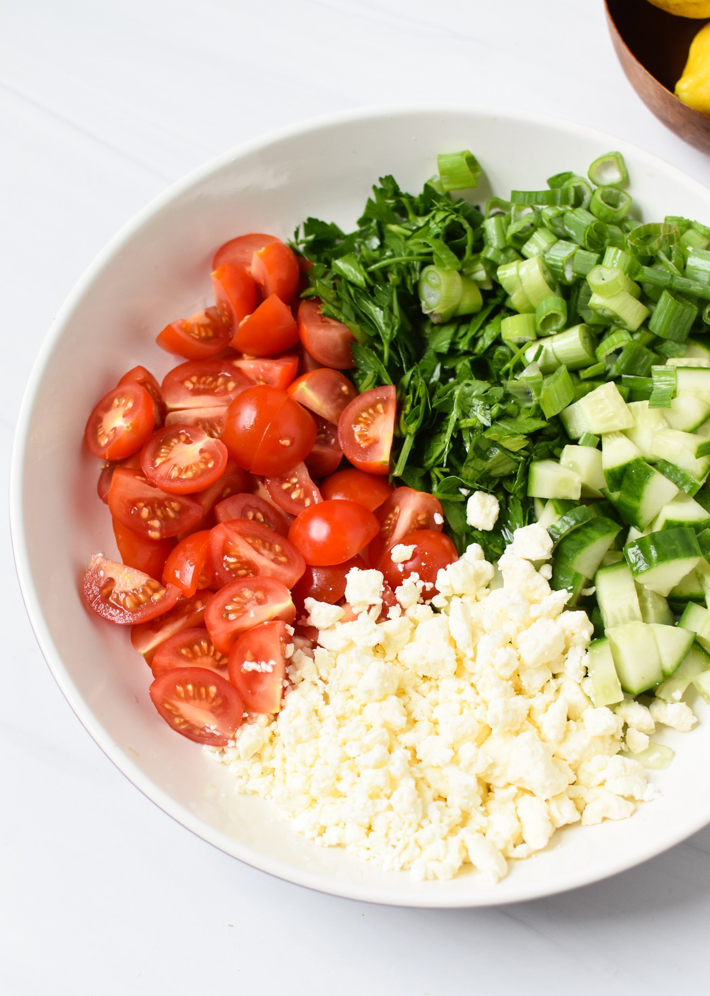 Air Fryer Mediterranean Chicken Thighs salad ingredients in a bowl. 