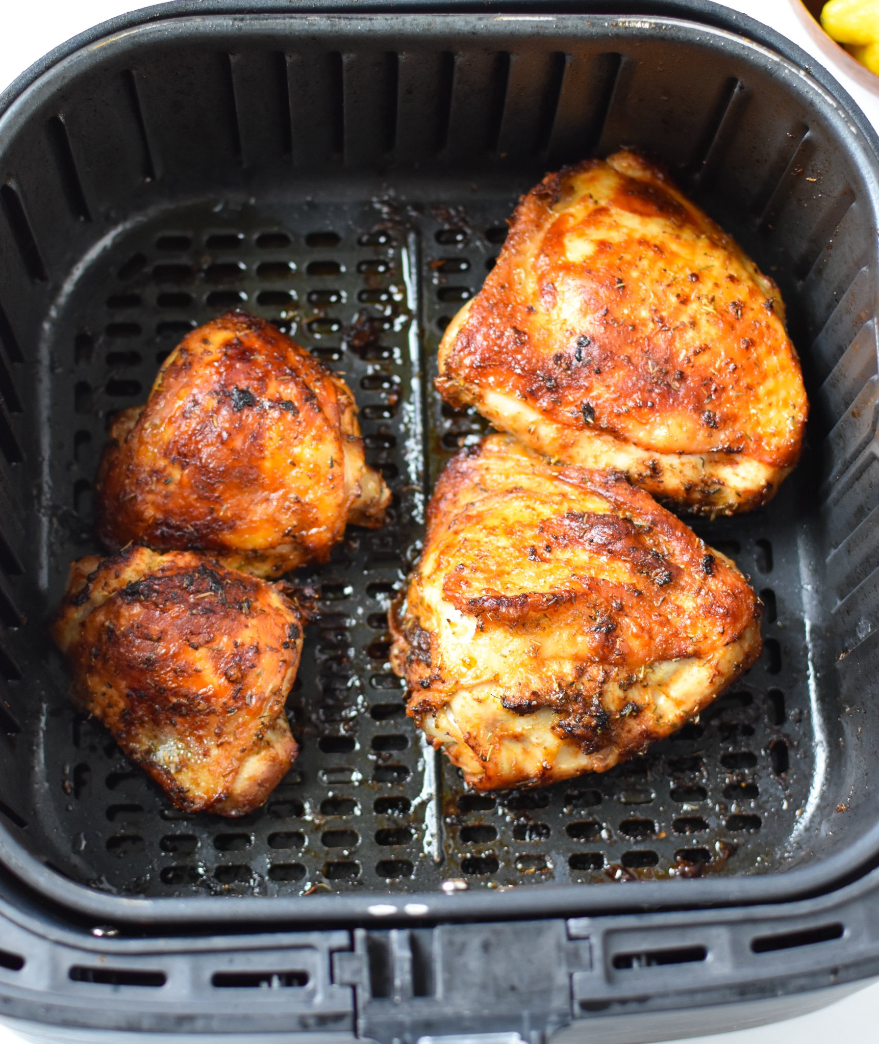 Air Fryer Mediterranean Chicken Thighs in an air fryer.