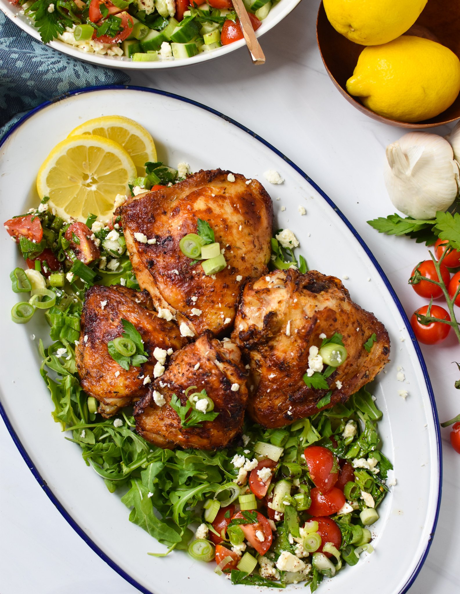 Air Fryer Mediterranean Chicken Thighs on white platter. 