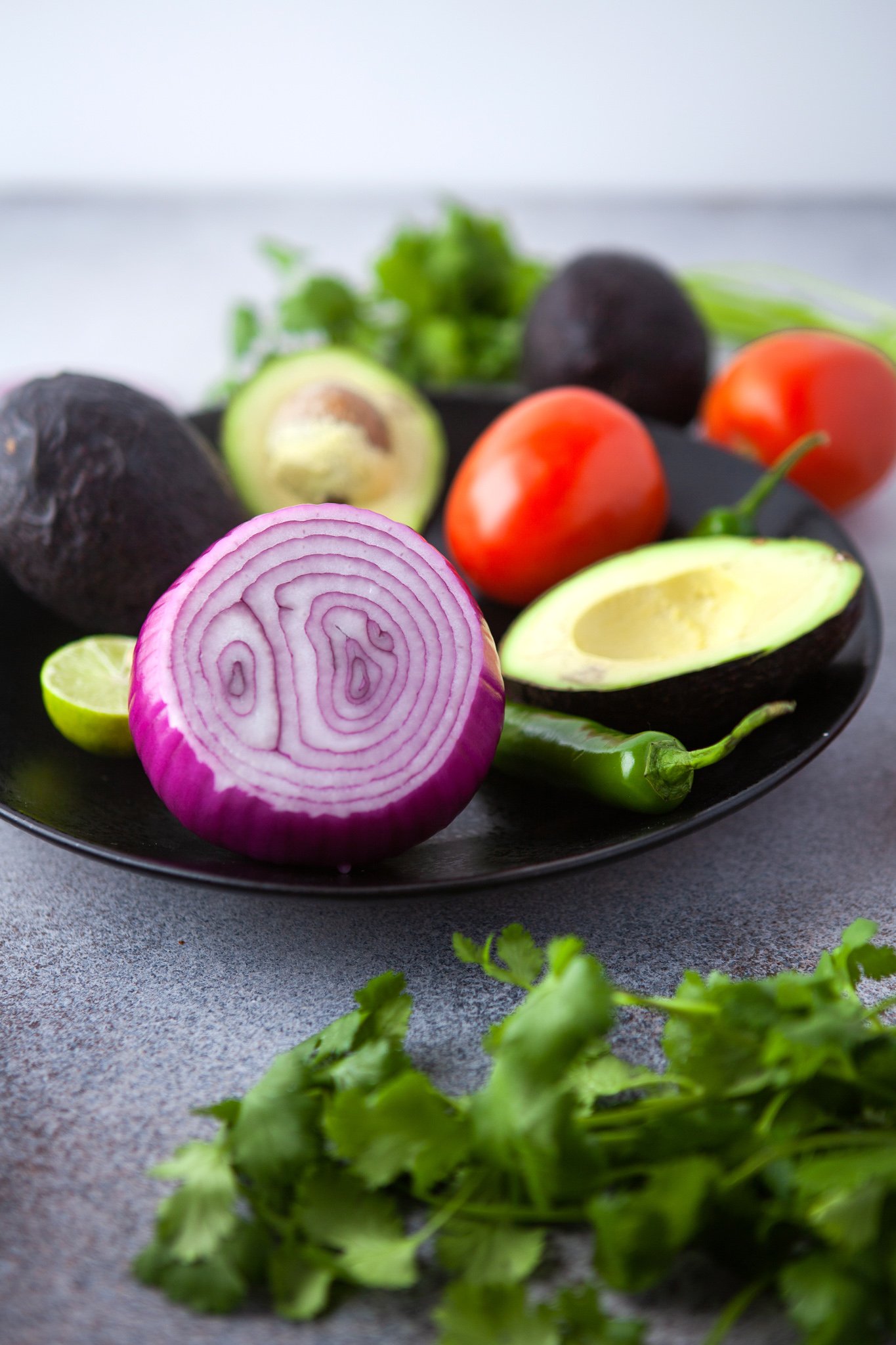 Easy Guacamole Recipe ingredients on plate. 