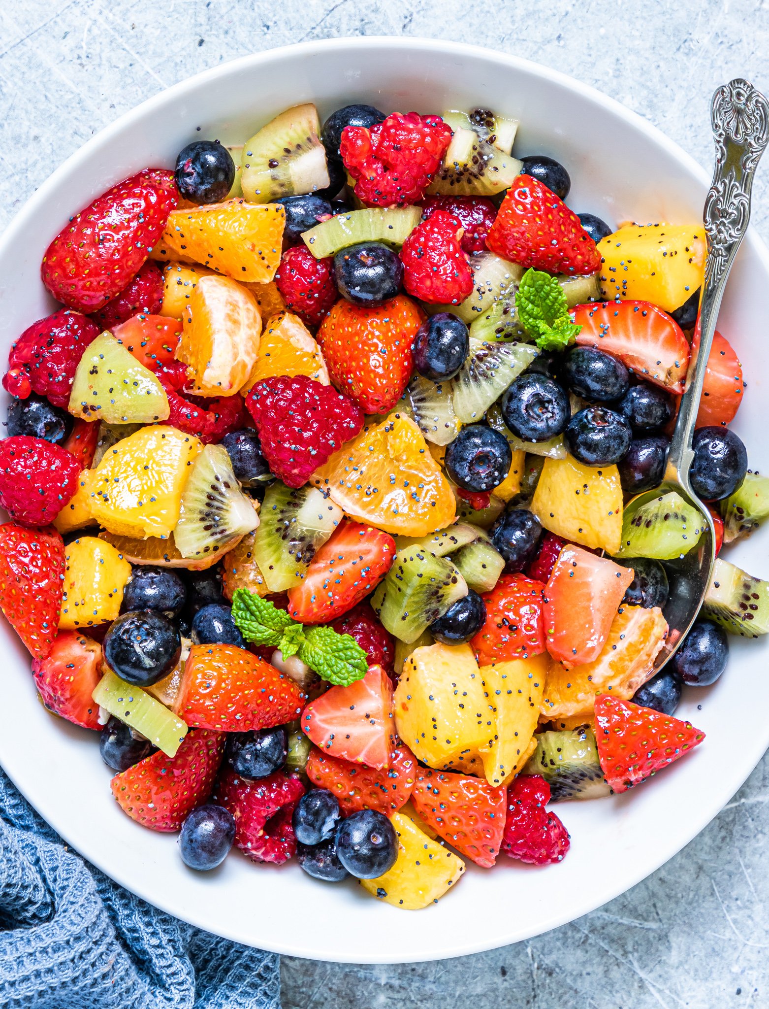 Fruit Salad with Lemon Poppy Seed Dressing with a spoon. 