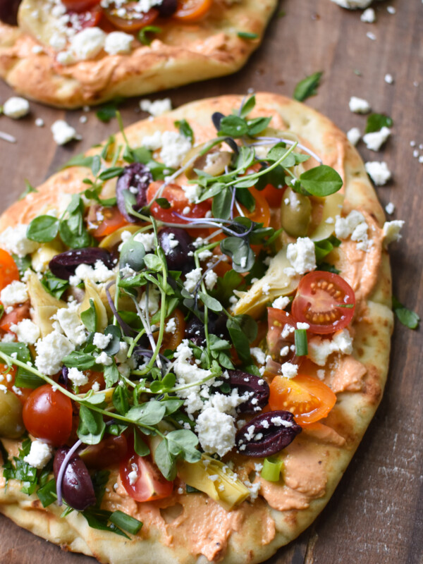 Mediterranean Naan Bread Pizza on a cutting board.