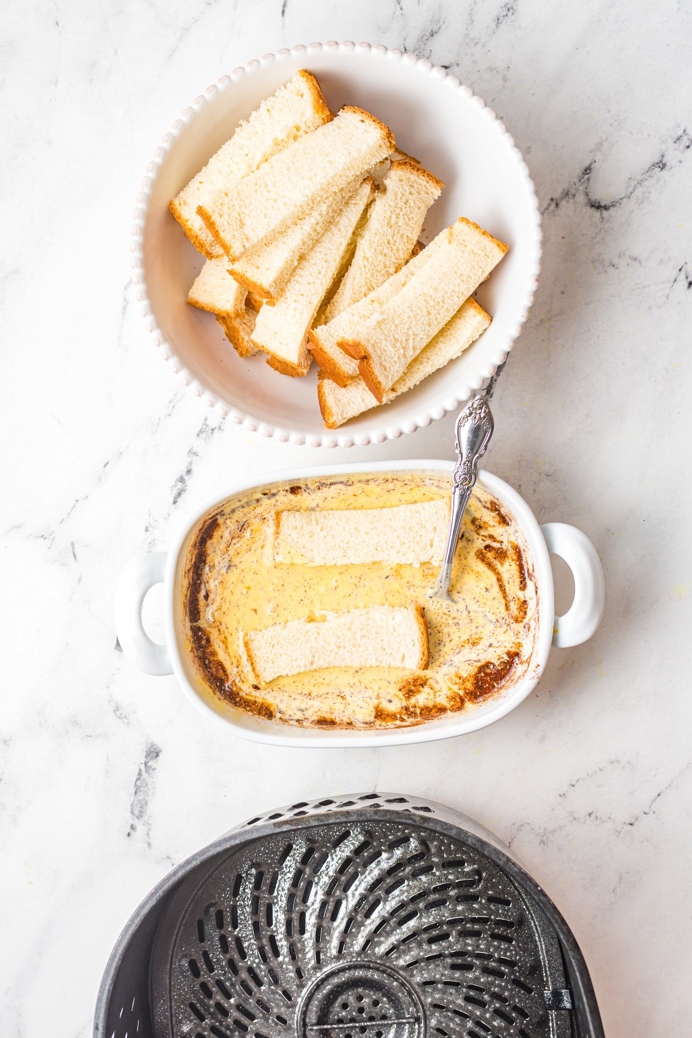 Air Fryer French Toast Sticks bread in dip. 