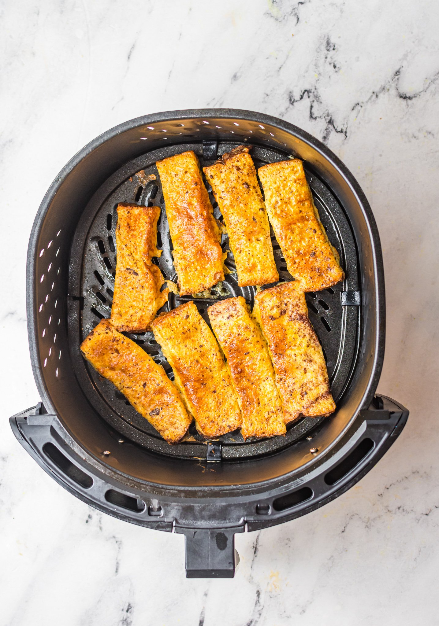 Air Fryer French Toast Sticks in air fryer.