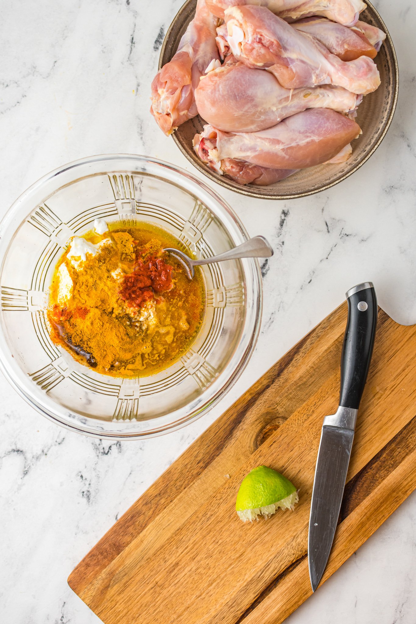 Air Fryer Tandoori Chicken Legs marinade in a bowl. 