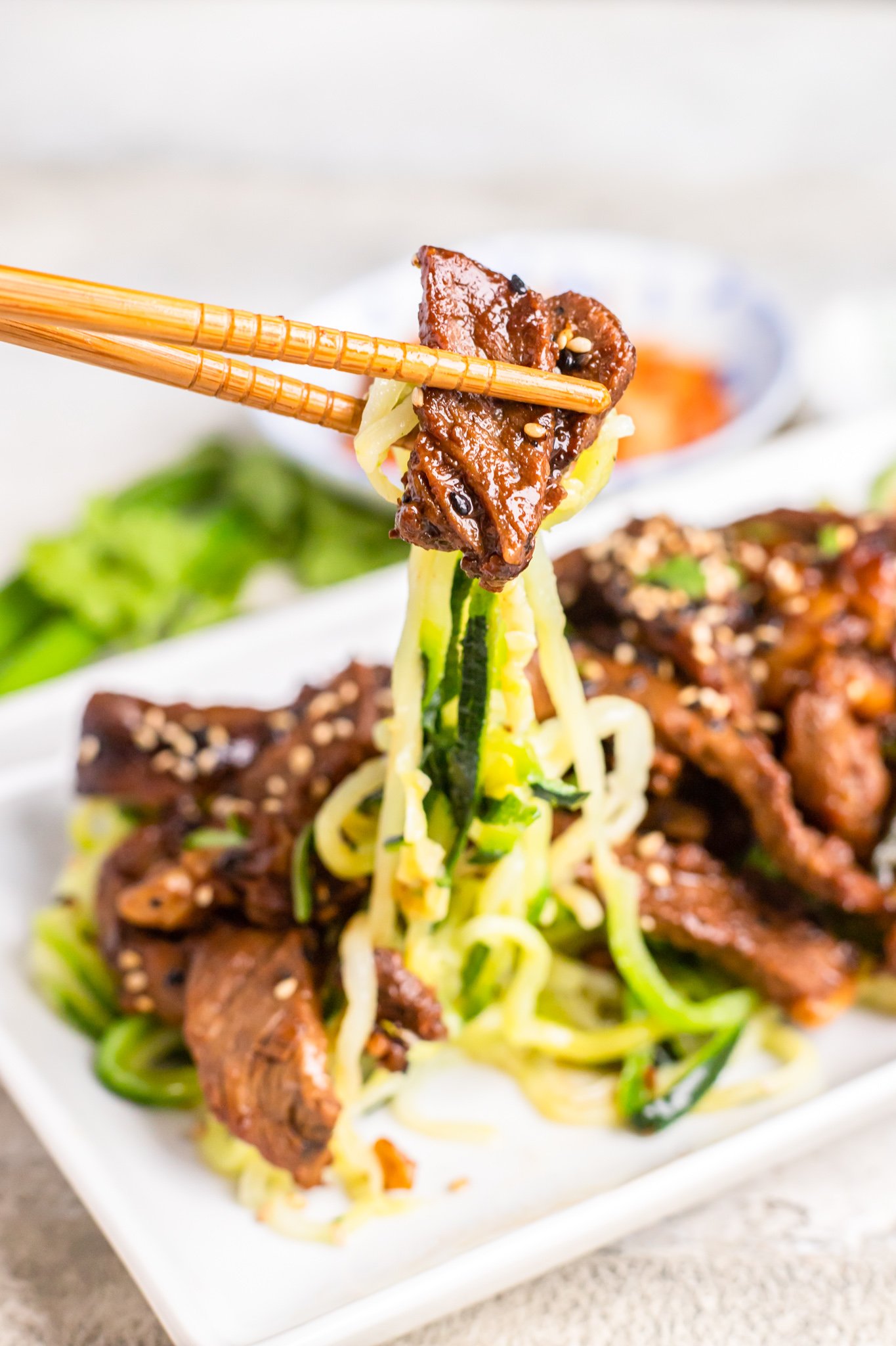 Beef Bulgogi with Zucchini Noodles with chopsticks. 