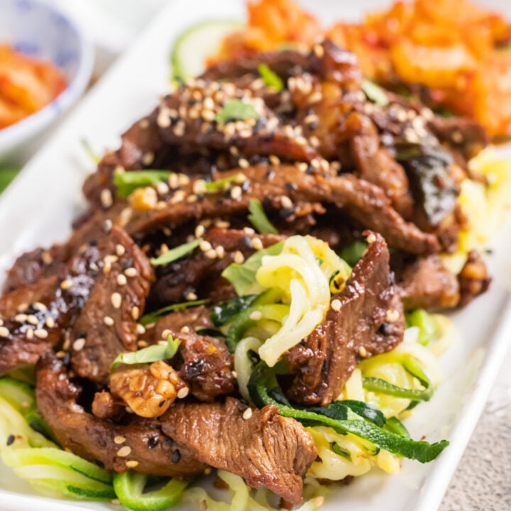 Beef Bulgogi with Zucchini Noodles on a white plate.