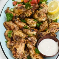 Grilled Mediterranean Chicken Wings with lemon slices.