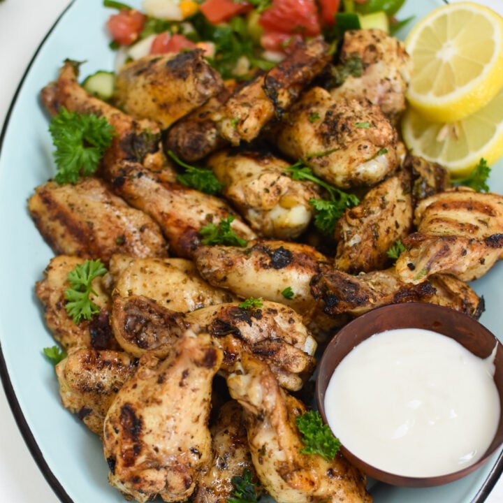 Grilled Mediterranean Chicken Wings with lemon slices.