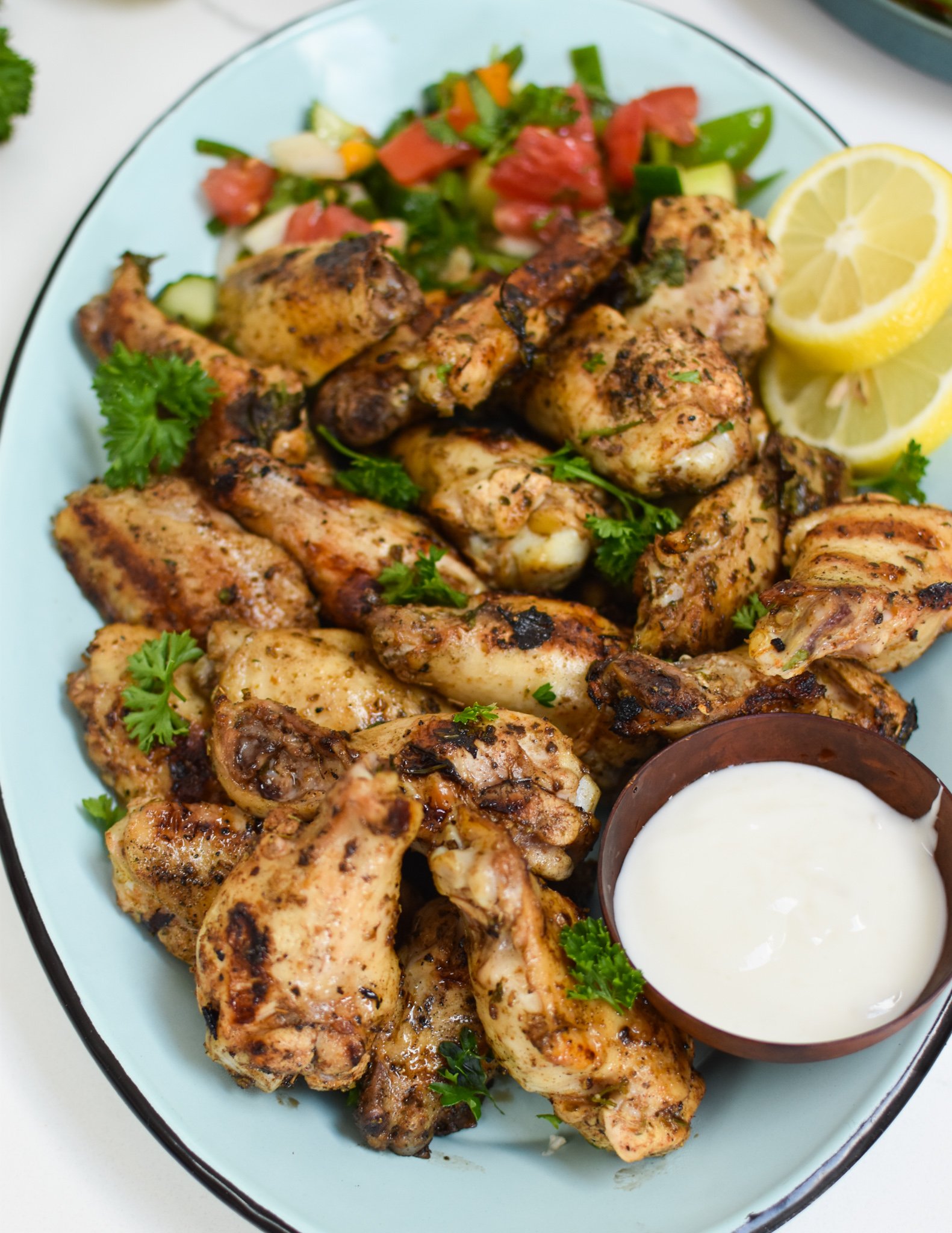 Grilled Mediterranean Chicken Wings with lemon slices. 