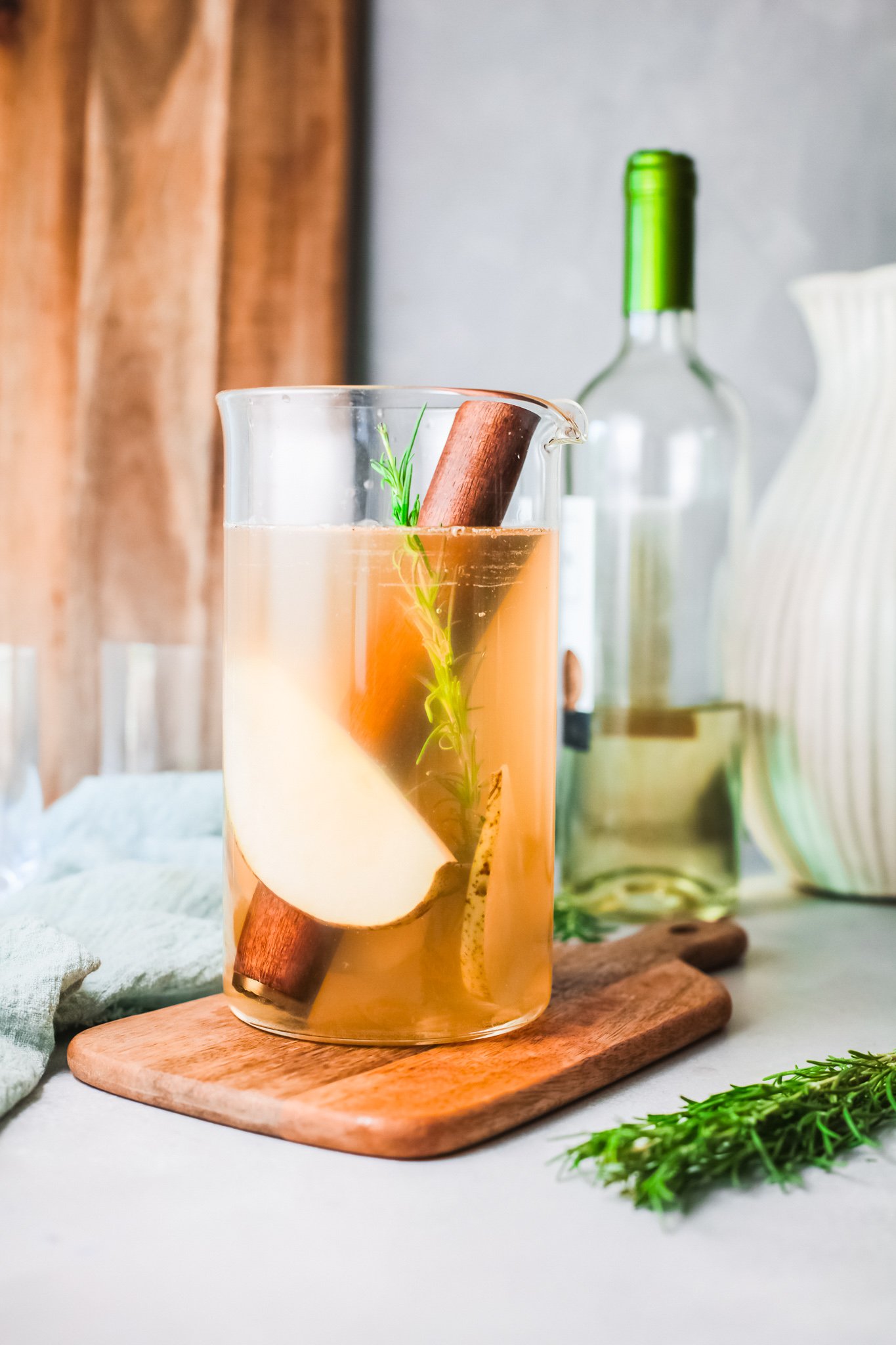 White Sangria Recipe pouring wine into pitcher. 
