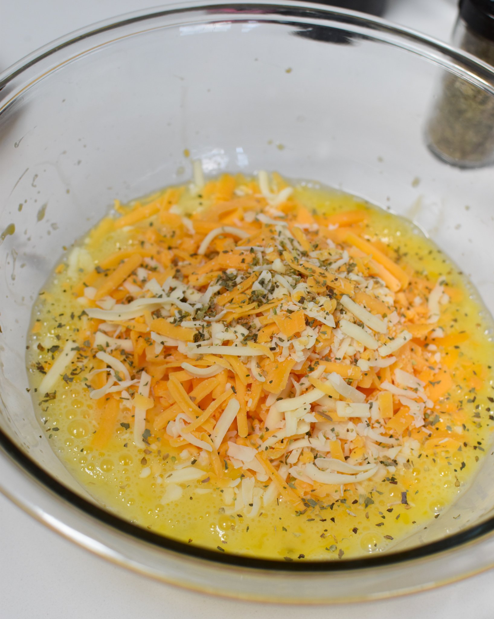 Chaffles Recipe eggs and cheese in a bowl. 
