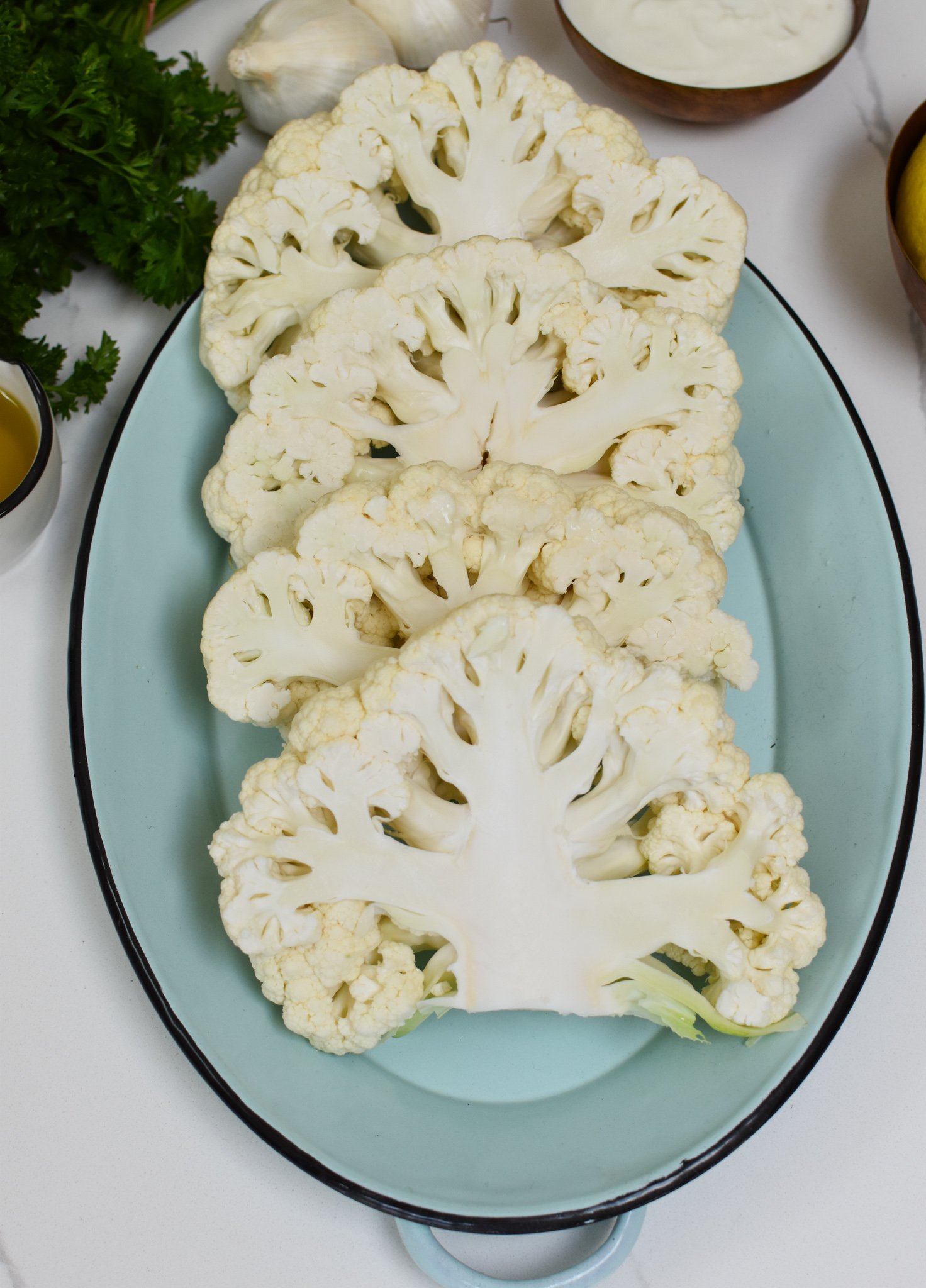 Grilled Cauliflower Steaks with Yogurt Tahini Sauce raw cauliflower. 