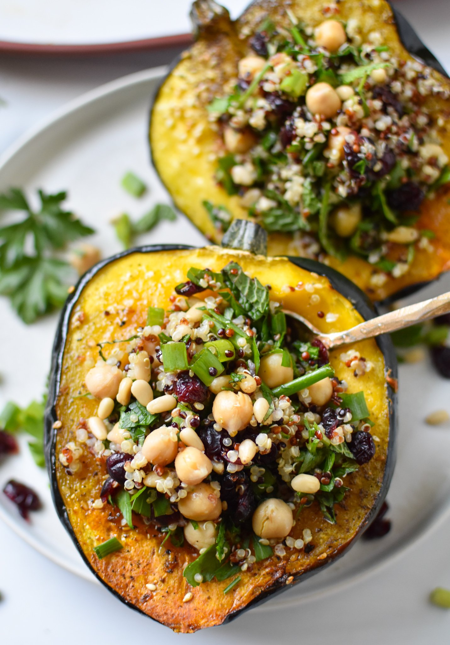 Mediterranean Stuffed Acorn Squash with spoon.
