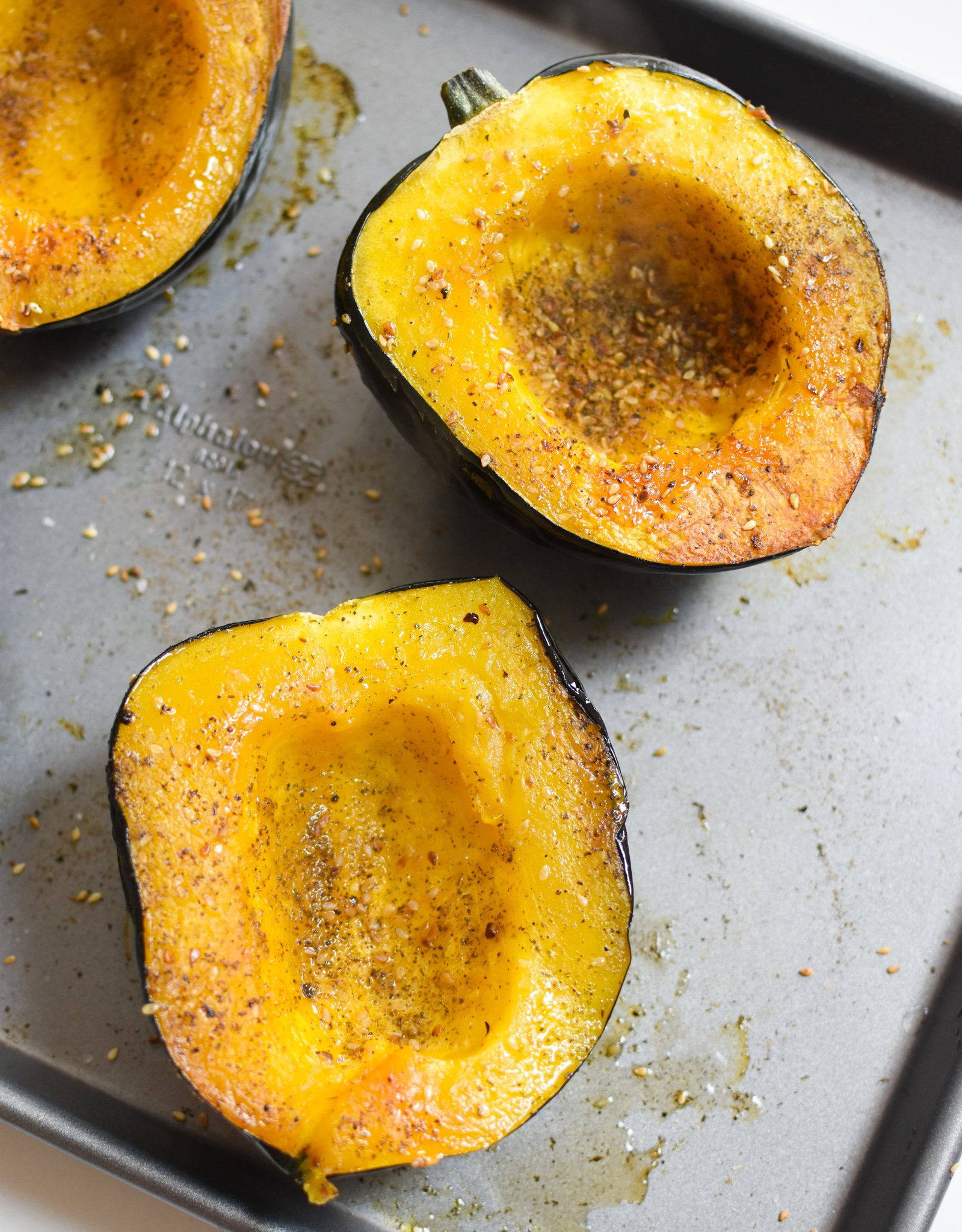 Mediterranean Stuffed Acorn Squash with salt and za'atar sprinkled on squash.