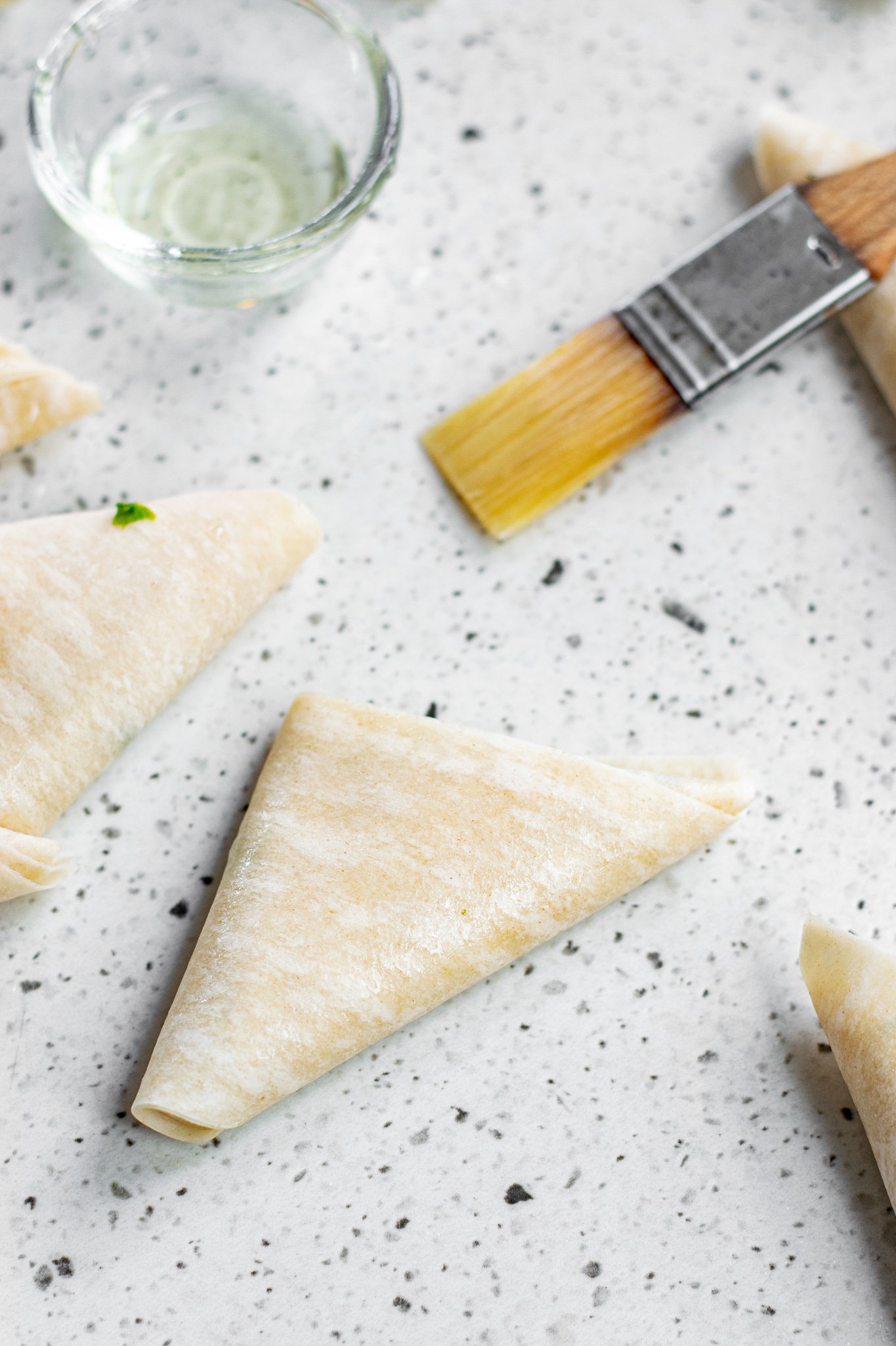 Spanakopita Triangles Recipe brushed with butter. 