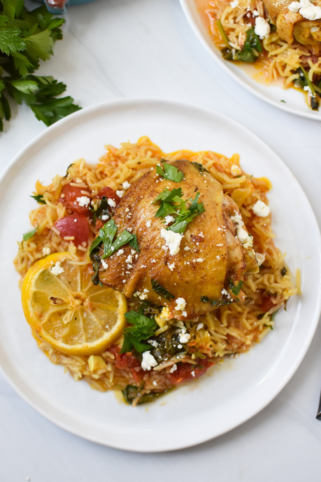 One Pot Mediterranean Chicken and Rice on white plate. 